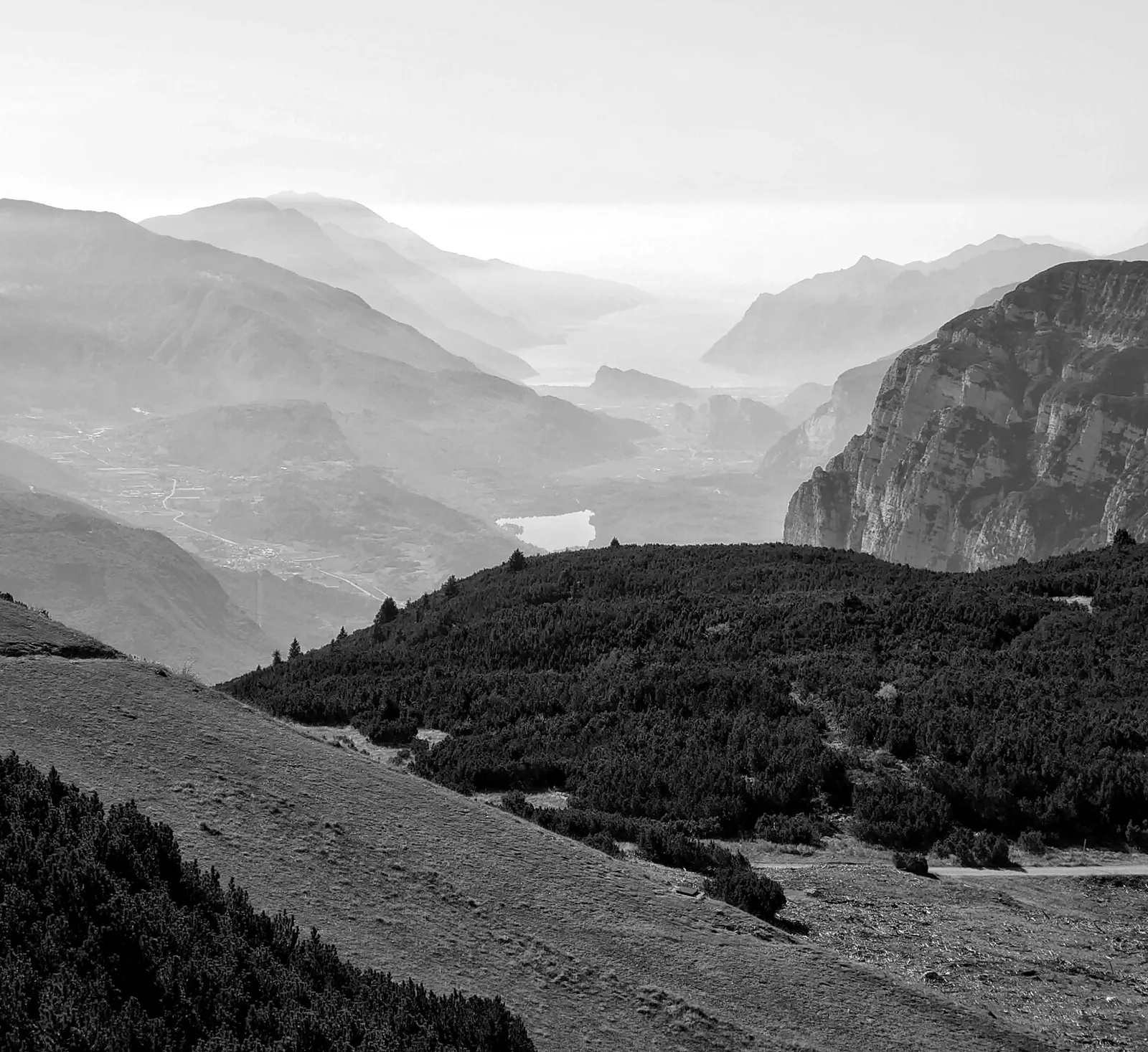A black-and-white photo of a mountain valley